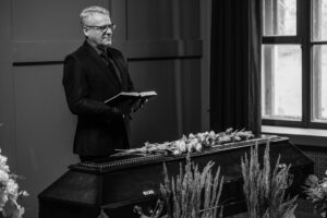 a man standing near the coffin